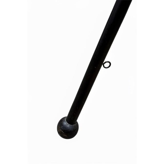 Elegant vintage folding coat and hat rack crafted from richly toned mahogany, featuring a tripod base with splayed legs...
