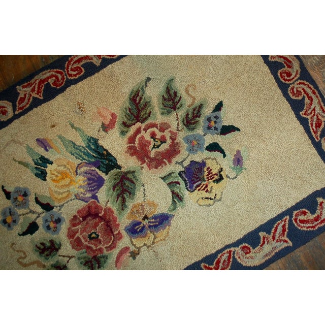 Hand made antique floral American hooked rug in original good condition. The rug made in floral design, the main shade is...