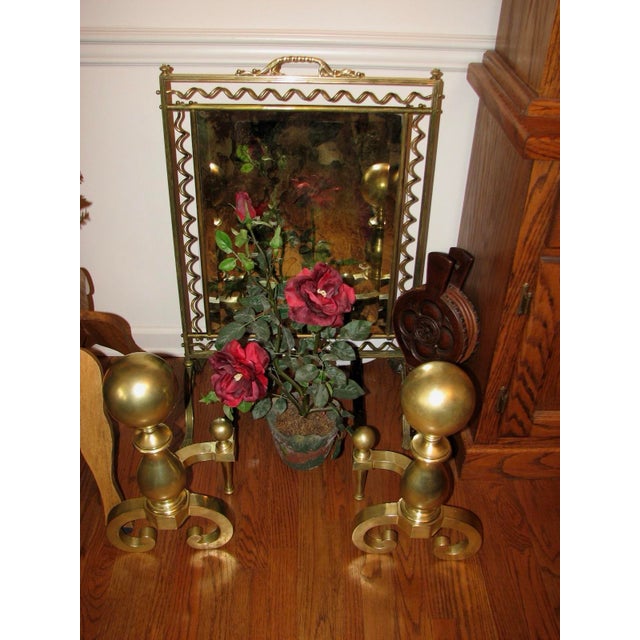 Two massive 5” brass ball fireplace Andiron’s with urn shaped shaft and c-shaped arched feet. 17 1/2” high x 10” wide....
