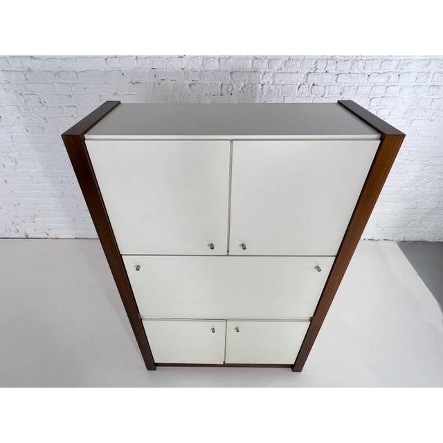 This Musterring bar/secretary unit offers ample storage. with a wooden frame and white satin lacquer finish, metal...