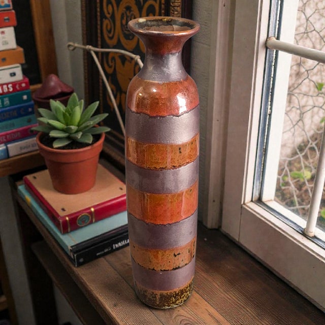 This Vintage Arts & Crafts Glazed Pottery Slender Striped 11'' Vase is a unique and handmade piece , featuring a striped...