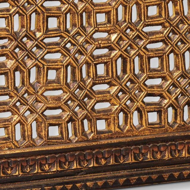 A beautifully crafted wooden jali panel featuring an intricate geometric lattice design centred around an elegant peacock...