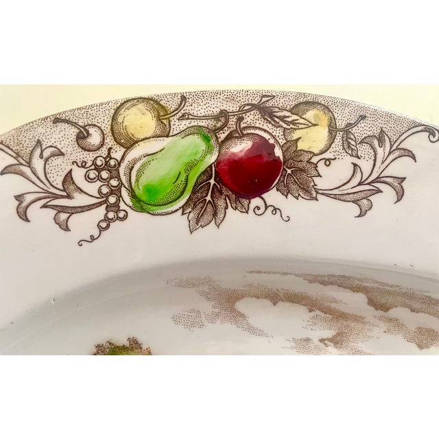 This large turkey platter is transferware decorated with shades of brown, green, blue, pink and yellow. It is seemingly...