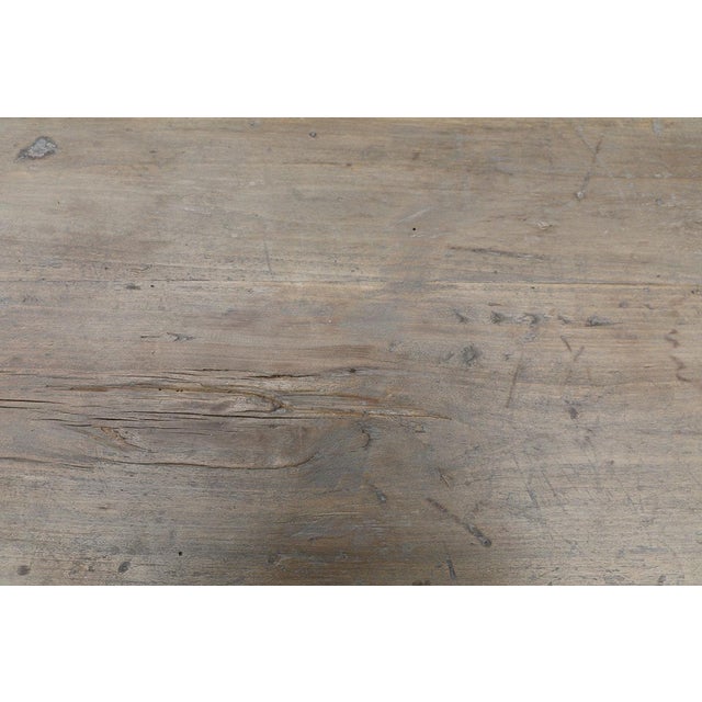 A beautifully rustic console table crafted from solid elmwood, dating to the first half of the 20th century. Its...