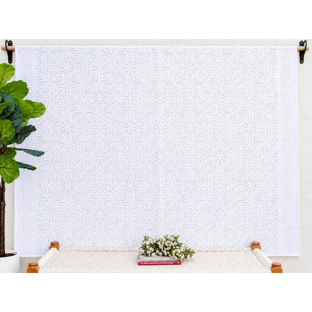 A lightweight cotton coverlet from Western India, beautifully adorned with intricate handcrafted appliqué cutwork. The...