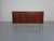Laminated, small sideboard in rosewood finish by Waiko from the 1970s. Two sliding doors. Behind each door is a large...