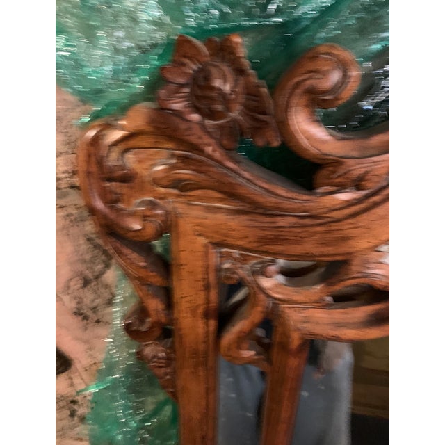 Antique wood carved mirror. Elegant mirror with ornate hand carved frame and dark wood color