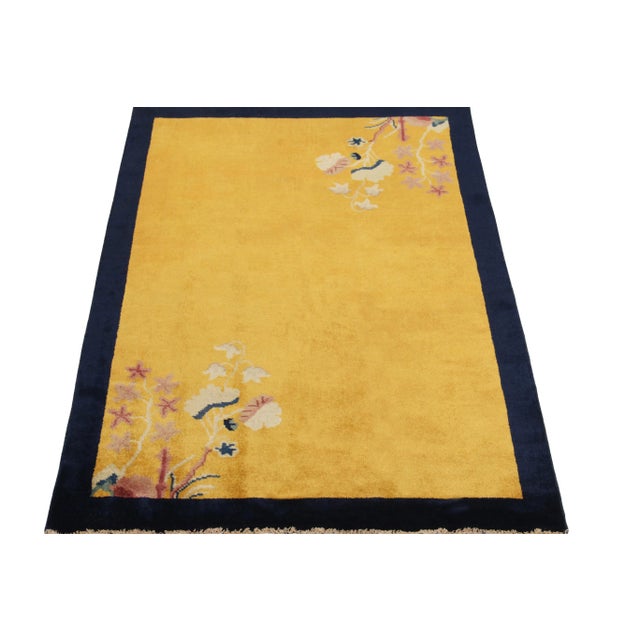 Hand-knotted in wool, this 3x5 vintage ode to Chinese art deco rugs of the 1920s features flowers flourishing in...