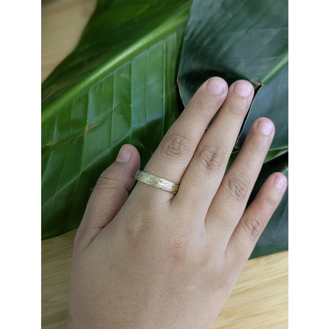 Crafted in solid 14K gold, this nature-inspired men’s ring features an organic tree bark texture that embodies strength...