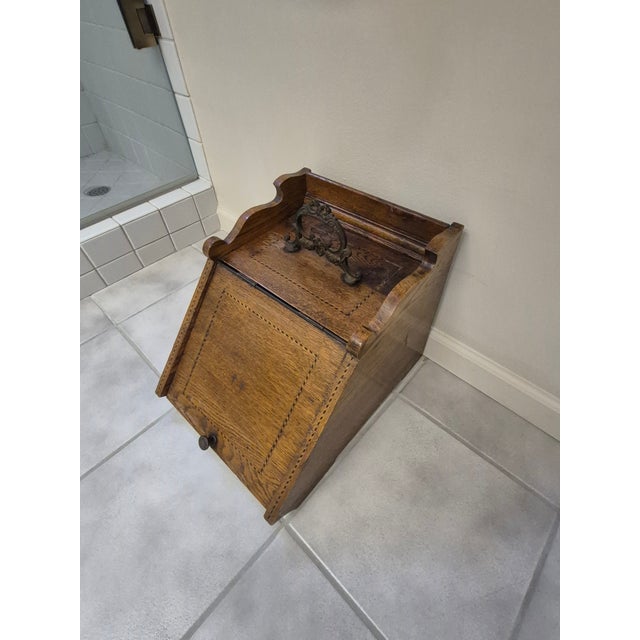 This is an antique English Victorian-era purdonium (coal scuttle box) crafted from solid oak. Key Features: Design:...