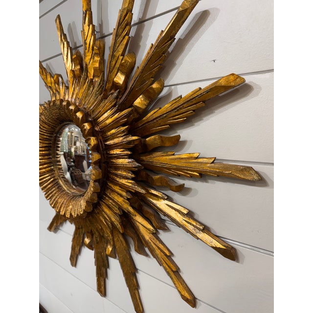 This is a gorgeous gilt wood convex mirror! Done in layered sunburst style, there are three layers of rays made up of...