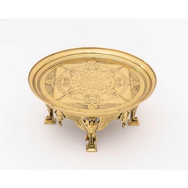 Egyptian Revival Brass Tazza, feet in the form of Horus, zodiac motif to plate. 6.5" H x 14.75" Diameter. Provenance: A...