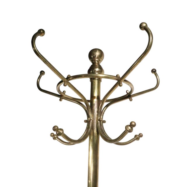 Classic brass freestanding coat rack, in very good, original, clean and ready to use condition. The coat tree features...