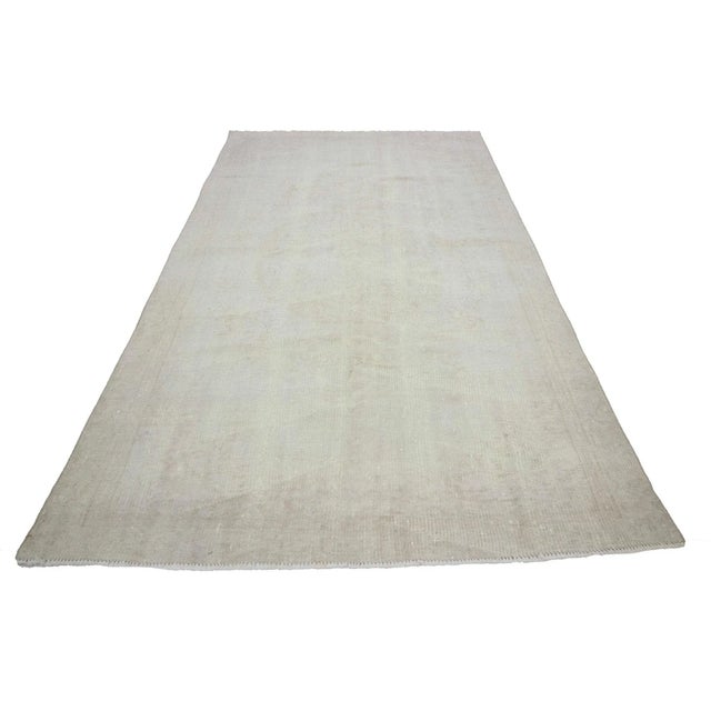 Washed out vintage handknotted rug from Oushak region of Turkey. Approximately 50-60 years old. In very good condition