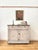 A lovely chippy painted wooden cupboard with a distressed grey finish, featuring three small top drawers and shelved...