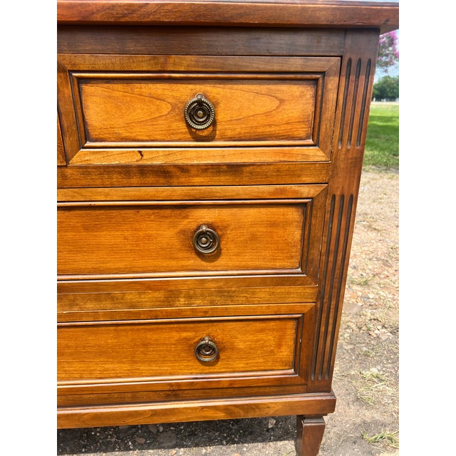 Elegant 19th-century Louis XVI commode crafted in walnut, featuring a clean, neoclassical design with upper drawers over...