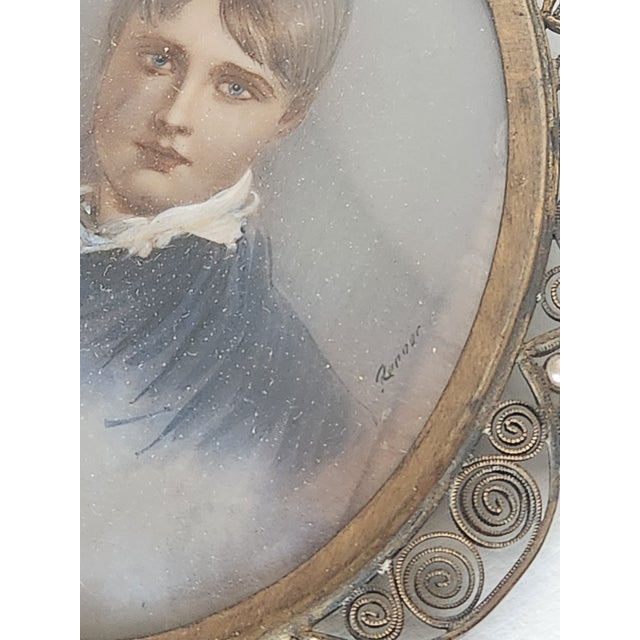 Beautiful mini portrait in double sided frame decorated with gilt bronze filigree and pearls. Back side of frame shows...