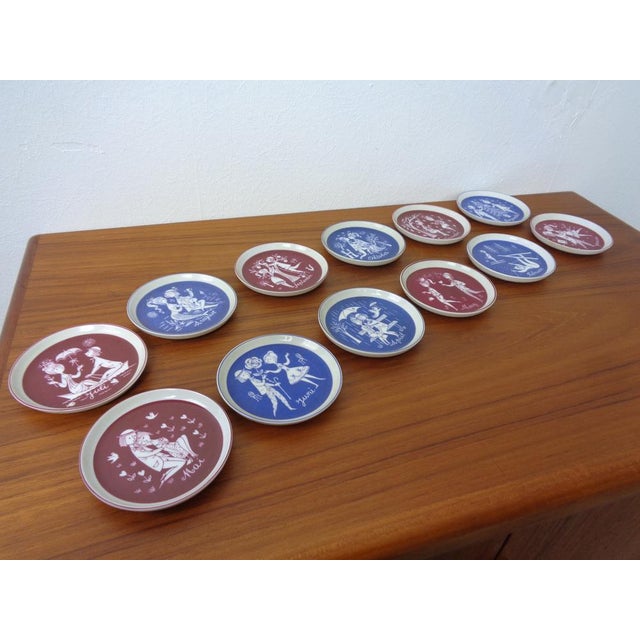 12 coasters from the 1960s. January December. Design: Raymond Peynet Production: Rosenthal This piece has an attribution...