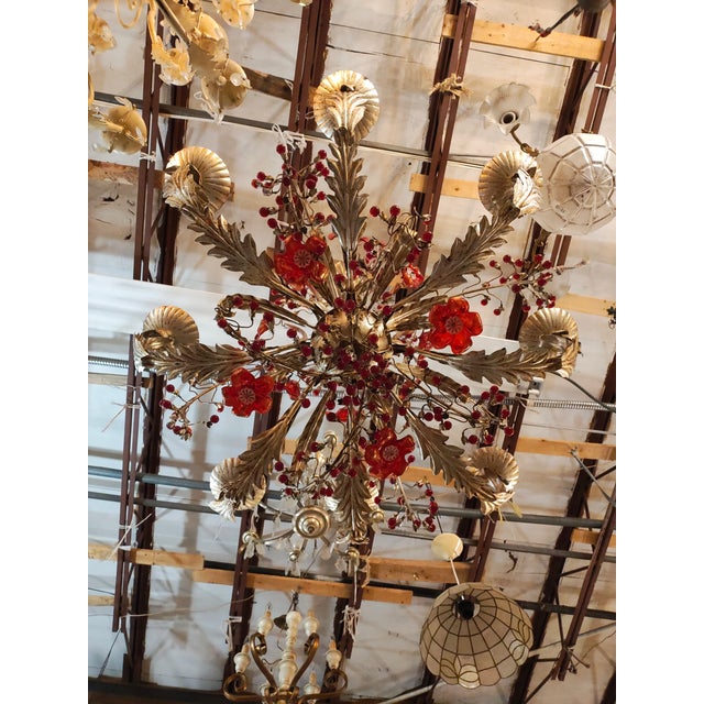 Decorative mid-century French chandelier sourced in Marseille and dating to the 1940s. Crafted in gilt metal with...