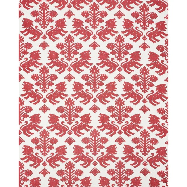 Regalia is an artisanal print featuring mirrored silhouettes of rampant lions and stylized flowers on a textural union...