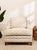 A generously proportioned vintage lounge chair upholstered in a beautiful champagne-toned jacquard with a repeating...