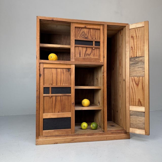 Charming small Japanese storage cabinet with a clean, minimalist design and a beautiful interplay of light wood and dark...