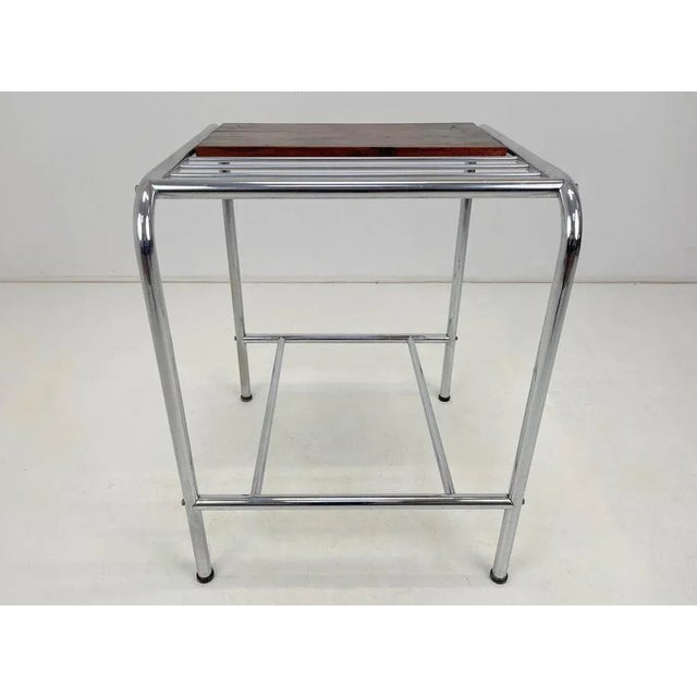 Functionalist or Bauhaus chrome side table with wooden shelf. Good original condition.
