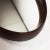 70s Oval mirror with leather strap. A compliment of modernism in excellent condition, to give your home a vintage touch!