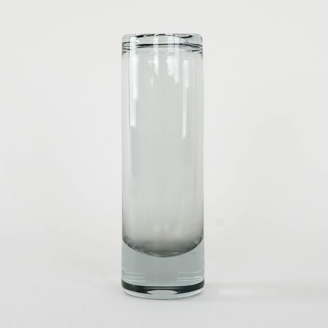 A vintage glass vase, manufactured in the 1970s by the renowned danish manufacturer holmegaard. a minimalist, cylindrical...