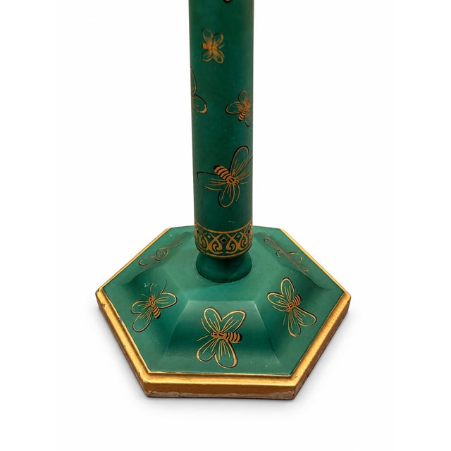 A whimsical table lamp with a green painted wood base, hand-painted gilt bees, and a decorative geometric border. The...