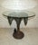 This incredibly sculpted side table evokes tropical themes with its palm tree base. A small monkey is seated at the base...