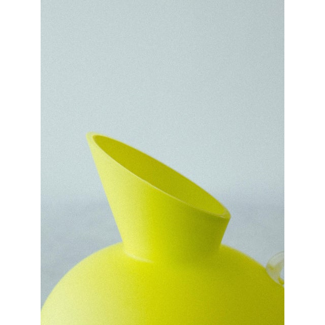 Lemon yellow art glass pitcher designed by Anne Nilsson for Kosta Boda, Sweden. Handblown glass in a vivid sorbet yellow...