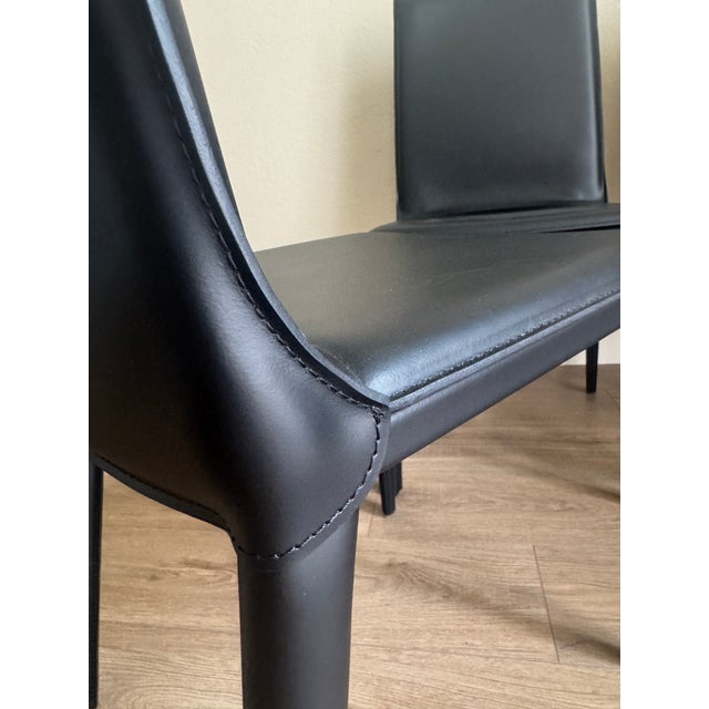 These chairs are in like new condition. Less than a year old, barely ever sat in. Bought new at DWR. 4 Chairs in Black...