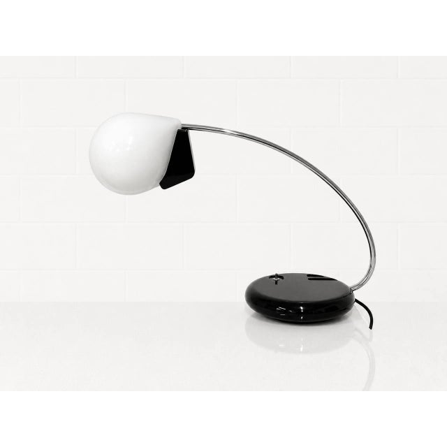 Iconic italian table lamp "dogale," designed in 1977 by bruno gecchelin for oluce. This futuristic design combines clean...
