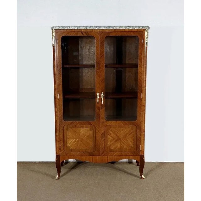 Elegant Transitional display cabinet made of mahogany veneers, precious woods This piece of furniture opens with two doors...