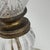 Vintage Hollywood Regency table lamp featuring a substantial cut-glass urn-form body with diamond-pattern detailing, brass...