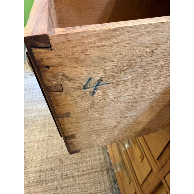 This is an antique apothecary cabinet circa 19th century. Each of the 15 drawers feature a brass medicine label. The wood...