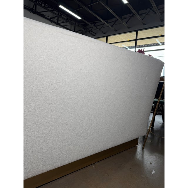 Tailored custom sofa upholstered in crisp white fabric, offering a clean, modern silhouette with generous, comfortable...