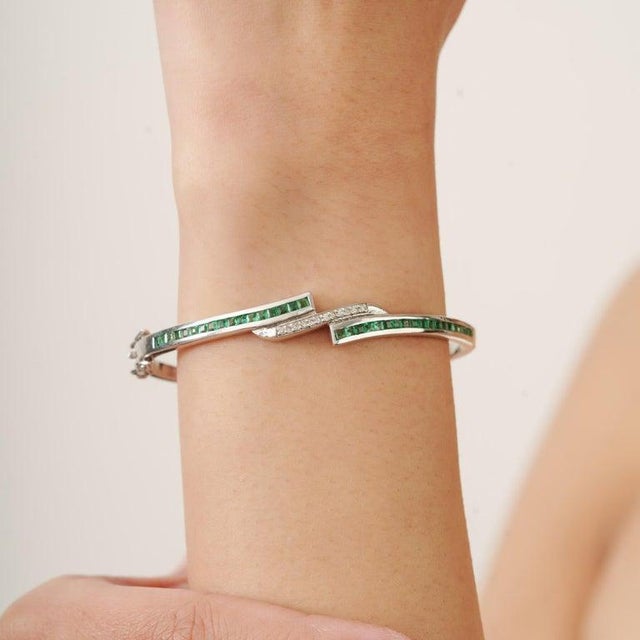 Add timeless sophistication to your jewelry collection with this stunning sterling silver emerald and diamond bracelet....