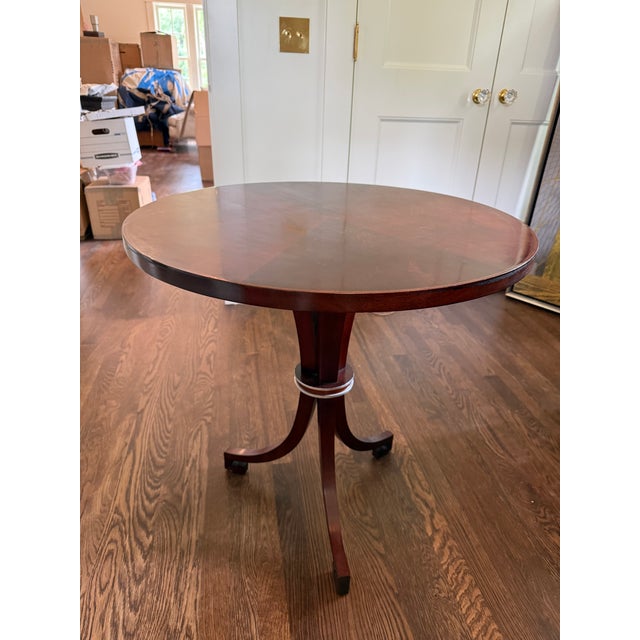 Lovely pedestal table by Bolier & Company, featuring swirl mahogany veneers, stainless banding, and distinctive greek key...
