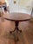 Lovely pedestal table by Bolier & Company, featuring swirl mahogany veneers, stainless banding, and distinctive greek key...