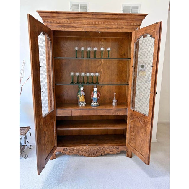 Offered is a one piece solid wood china display cabinet by Hickory Furniture. This piece has had one owner and impeccably...