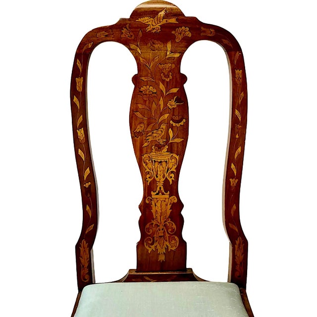 This pair of 19th-century Dutch-style side chairs features highly decorative inlays of flower urns, tulips, foliage,...