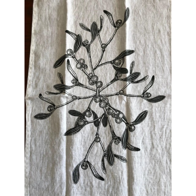 Beautiful white German linen table runner printed with mistletoe in the center. Measures 40cm x 150cm. Table in image is...