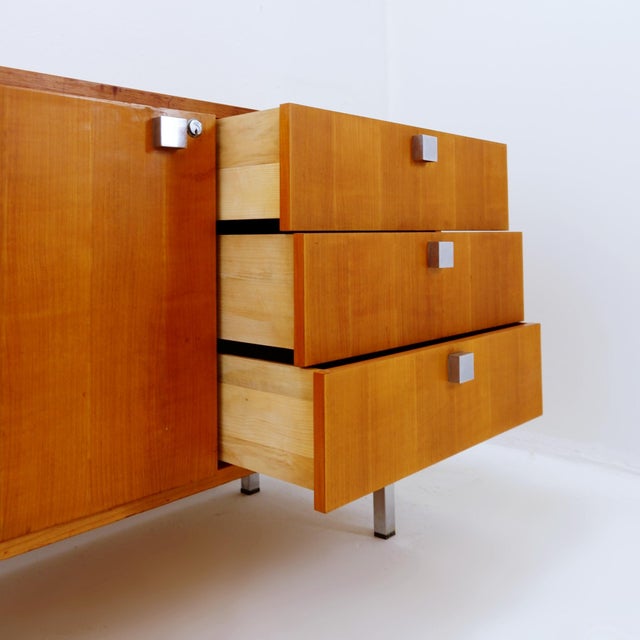 Sleek and minimalist mid-century Belgian design. Measures : 120.5x48cm - H: 76cm -Sideboard in teak, designed by Alfred...