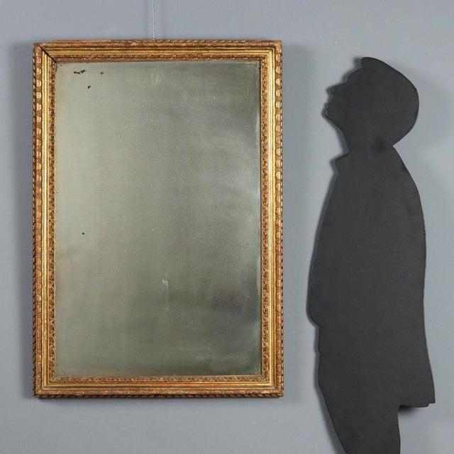 Carved and gilded fir mirror. Frame decorated with leaf and ribbon carvings, some missing parts. Lombardy, late 18th...