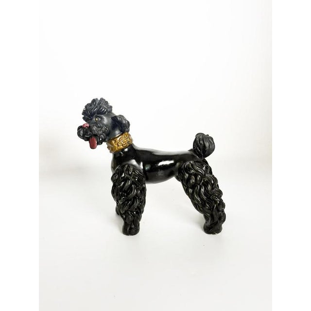 Charming French decorative sculpture dating from the 1970s, depicting a stylized poodle crafted from plaster. The dog...
