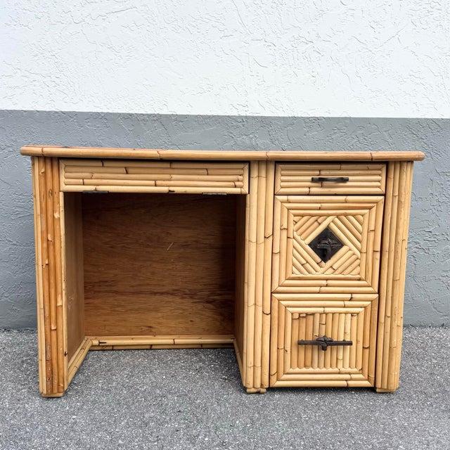 Charming vintage boho chic writing desk crafted in pencil reed bamboo, showcasing warm natural tones and coastal...