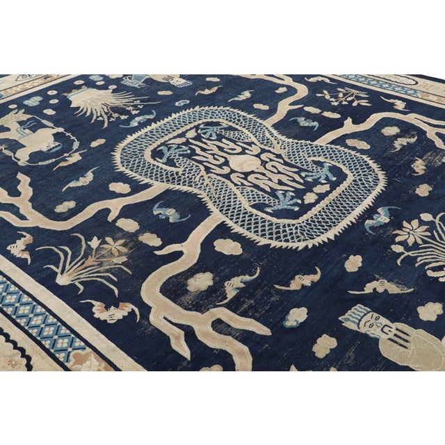 Made with hand-knotted wool and originating from China, this 11x13 oversized antique Peking rug features an intricate...