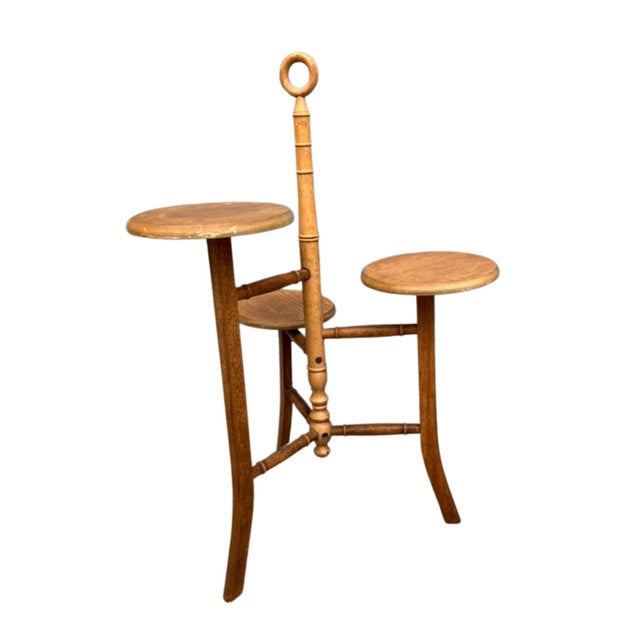 Mid-Century Modern oak plant stand or side table composed of a large center pole with tripod base and graduated height,...